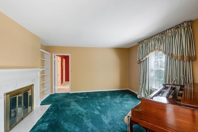 107 Leslie Ln, Hohenwald, TN 38462 - interior space featuring baseboards, carpet flooring, built in shelves, and a premium fireplace