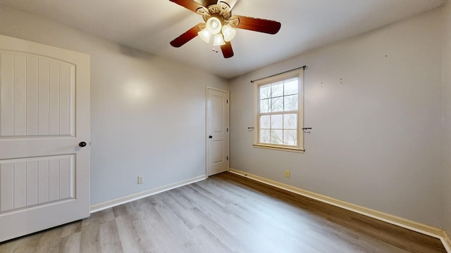 unfurnished room featuring baseboards, a ceiling fan, and wood finished floors