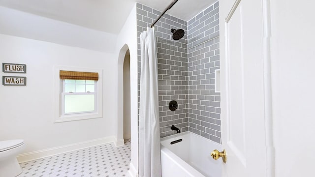 full bath with baseboards, tile patterned floors, toilet, and shower / bath combination with curtain