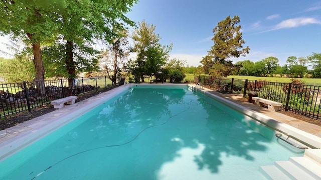 view of pool with a fenced in pool and fence