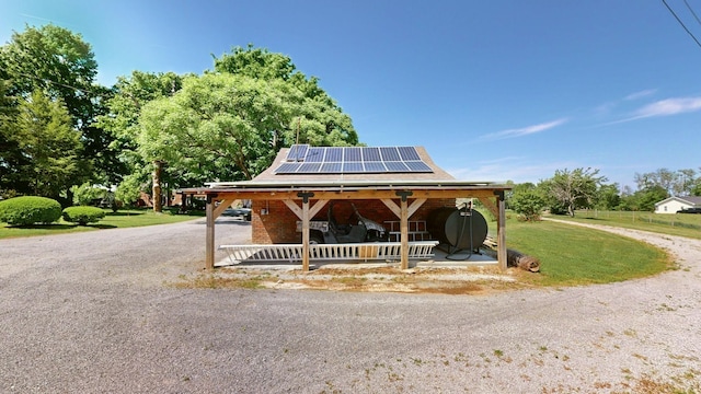 surrounding community featuring a lawn and gravel driveway