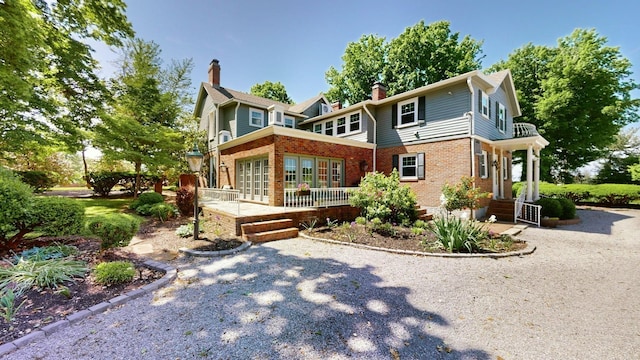 exterior space with brick siding and a chimney