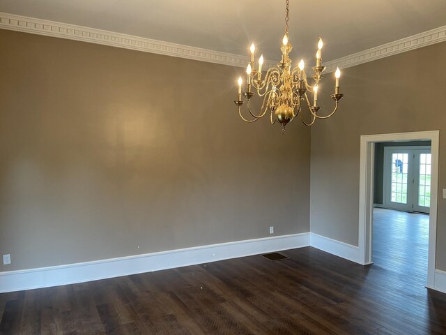 11495 Guthrie Rd, Guthrie, KY 42234 - unfurnished room with baseboards, an inviting chandelier, ornamental molding, and dark wood finished floors