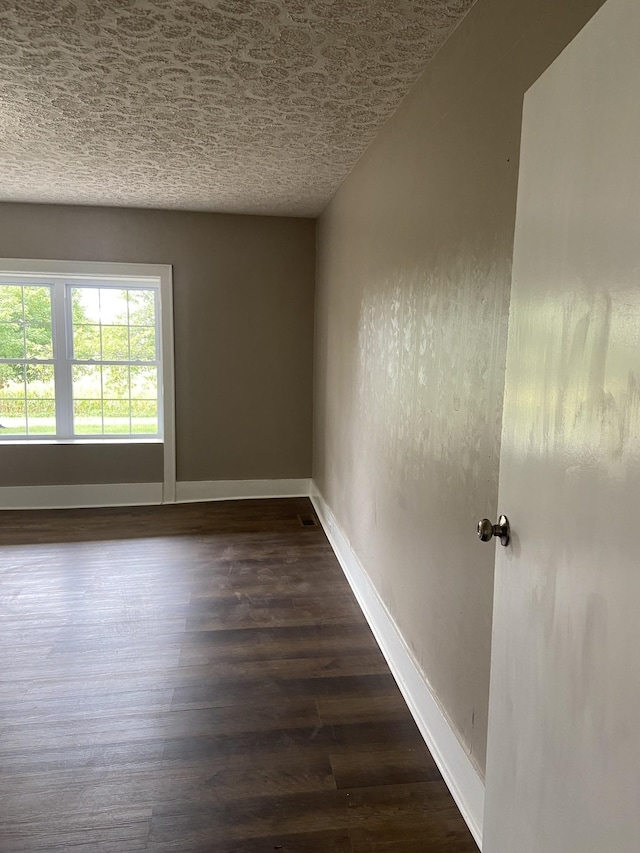 11495 Guthrie Rd, Guthrie, KY 42234 - spare room with baseboards, a textured ceiling, and dark wood finished floors