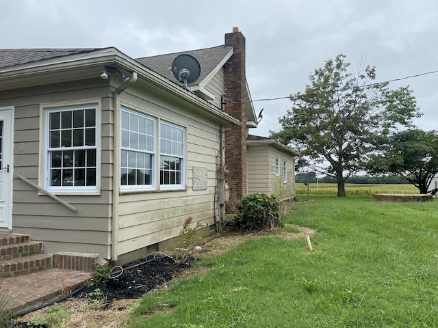 11495 Guthrie Rd, Guthrie, KY 42234 - view of side of home with a yard, a chimney, a shingled roof, and entry steps