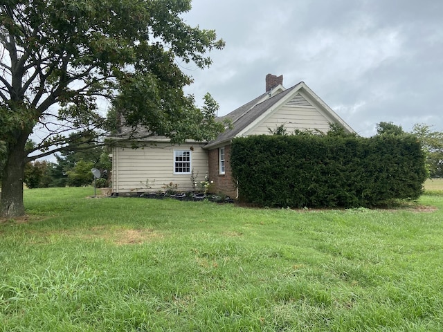 11495 Guthrie Rd, Guthrie, KY 42234 - view of property exterior with a lawn and a chimney
