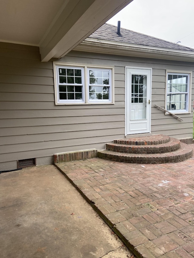 11495 Guthrie Rd, Guthrie, KY 42234 - property entrance with roof with shingles and a patio area