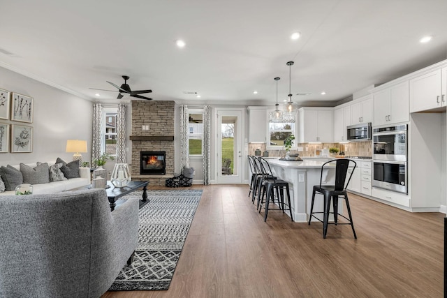 952 Pleasant Ridge Run, Mount Juliet, TN 37122 - living area with a ceiling fan, a fireplace, recessed lighting, light wood-style floors, and ornamental molding