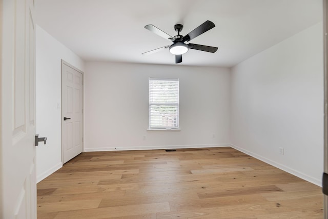 empty room with light wood-style floors, baseboards, and ceiling fan