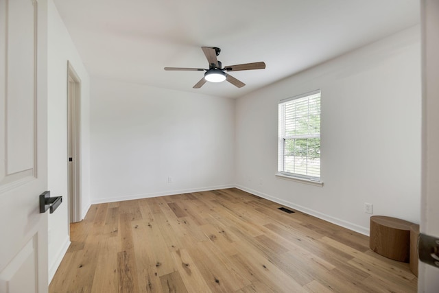 empty room with visible vents, light wood-style floors, ceiling fan, and baseboards