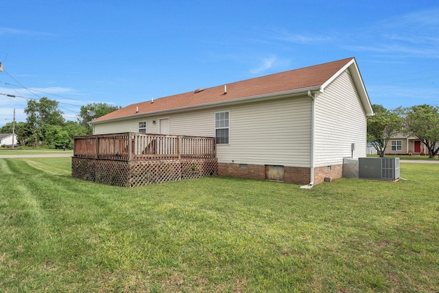 back of property featuring a lawn, cooling unit, a deck, and crawl space