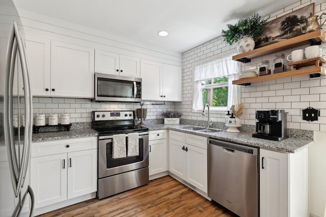557 Skyview Dr, Ashland City, TN 37015 - kitchen featuring stainless steel appliances, decorative backsplash, a sink, and white cabinetry