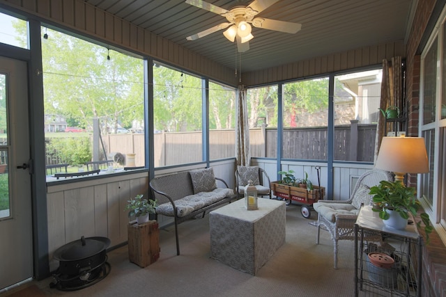 sunroom / solarium with plenty of natural light, ceiling fan, and an outdoor living space