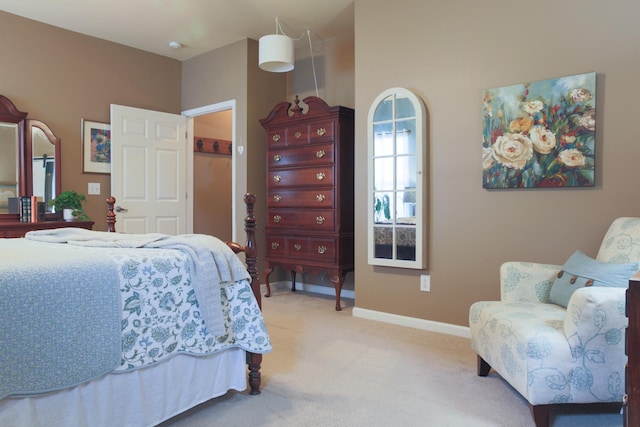 bedroom with baseboards and light colored carpet