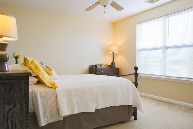 bedroom with carpet flooring, baseboards, multiple windows, and ceiling fan