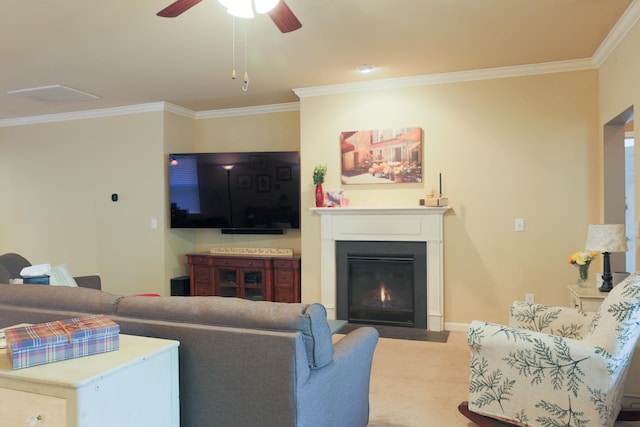 living room featuring crown molding, ceiling fan, baseboards, a fireplace with flush hearth, and visible vents