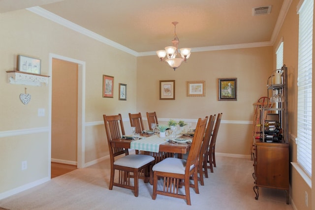 dining space featuring light colored carpet, a notable chandelier, ornamental molding, and visible vents