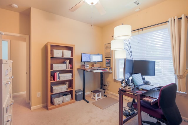 carpeted home office with ceiling fan, visible vents, and baseboards
