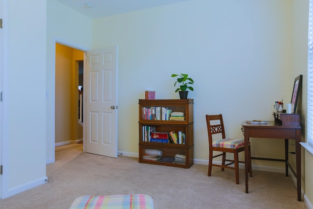 sitting room featuring baseboards and carpet flooring