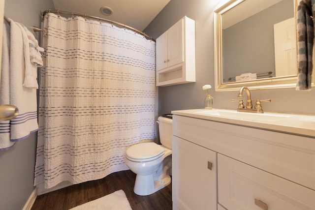 full bath with vanity, a shower with shower curtain, wood finished floors, and toilet