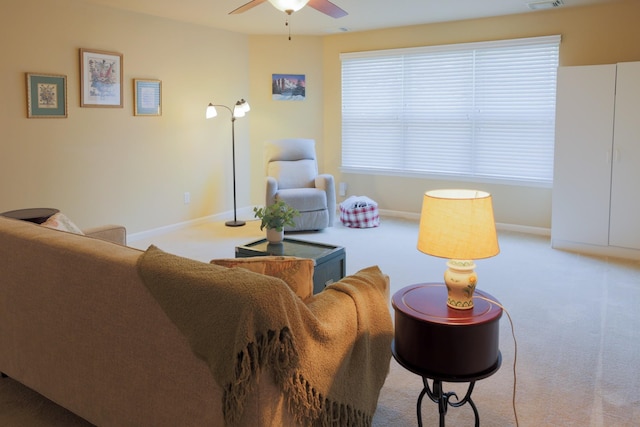 living area with baseboards, ceiling fan, carpet, and visible vents