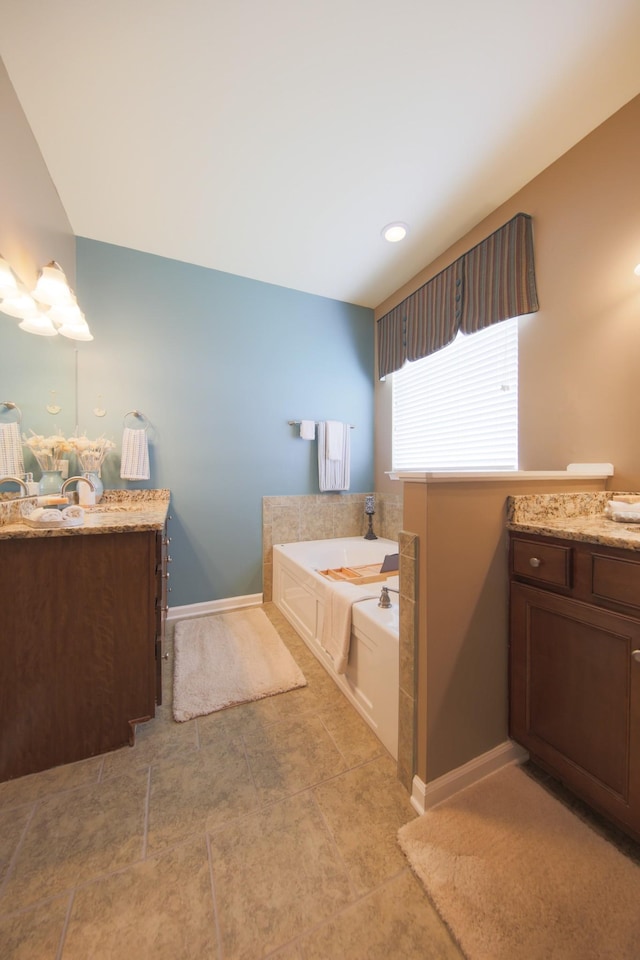 bathroom featuring vanity and a garden tub