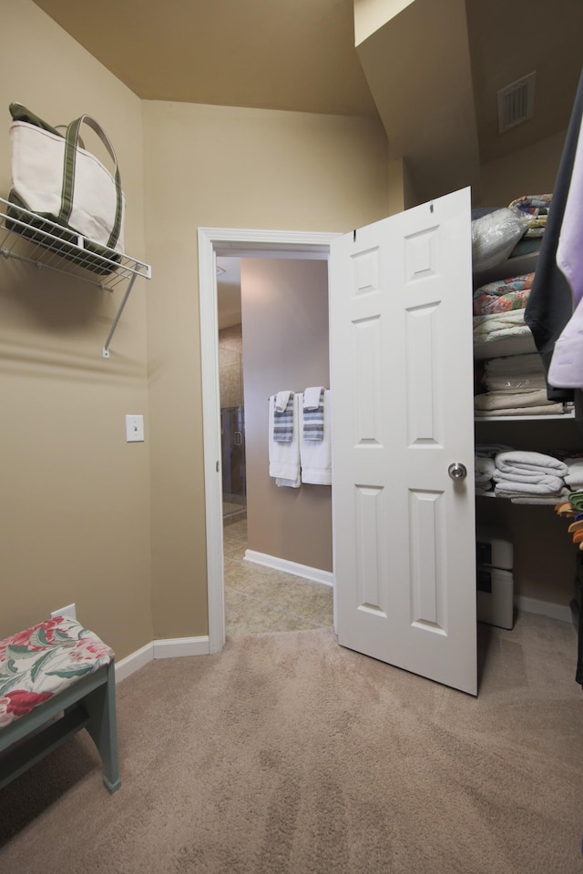 spacious closet with carpet floors and visible vents