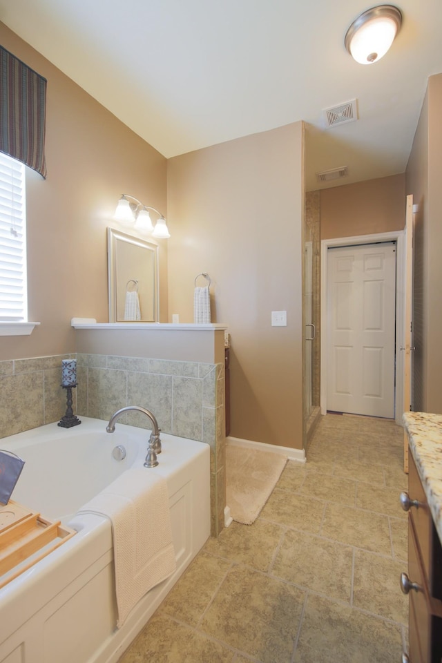 bathroom with visible vents, a stall shower, a bath, and vanity