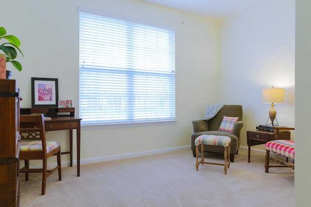 living area featuring carpet floors and baseboards