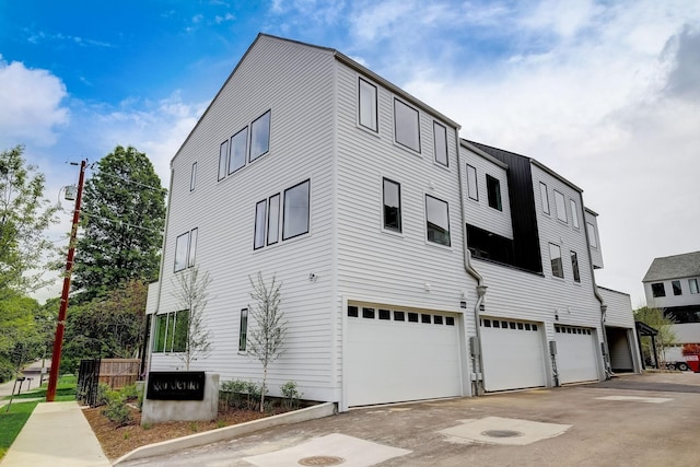 view of building exterior with a garage and driveway