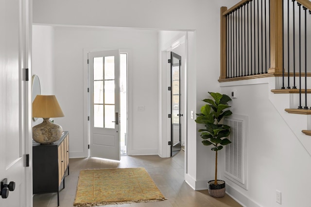 entrance foyer featuring baseboards and visible vents