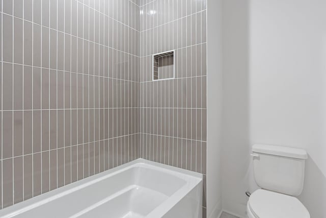 bathroom featuring a washtub, walk in shower, and toilet