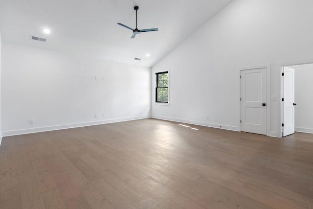 unfurnished room with high vaulted ceiling, ceiling fan, wood finished floors, and visible vents