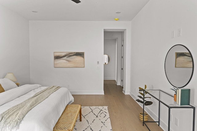 bedroom featuring baseboards and wood finished floors
