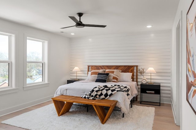 bedroom featuring baseboards, multiple windows, light wood-type flooring, and recessed lighting