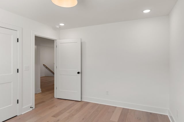 unfurnished bedroom with light wood-style floors, baseboards, and recessed lighting