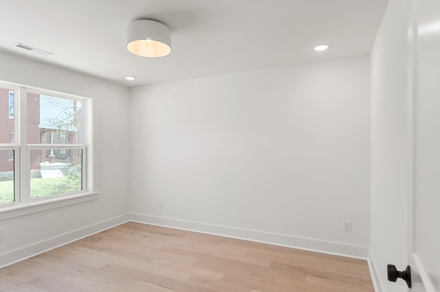 empty room featuring visible vents, recessed lighting, light wood-style flooring, and baseboards