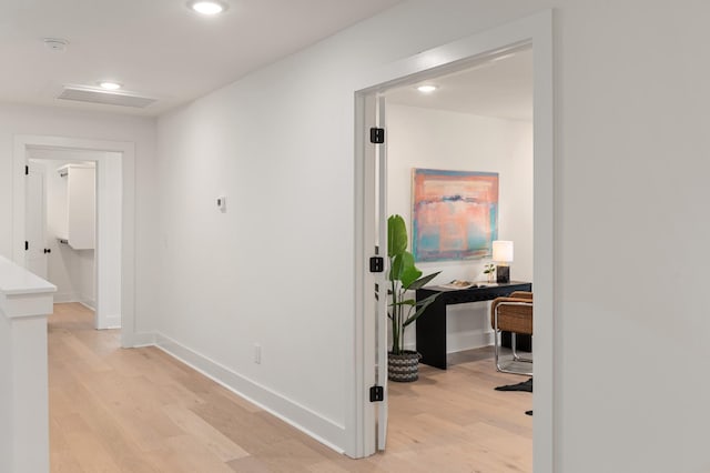 corridor with recessed lighting, baseboards, visible vents, and light wood-style floors