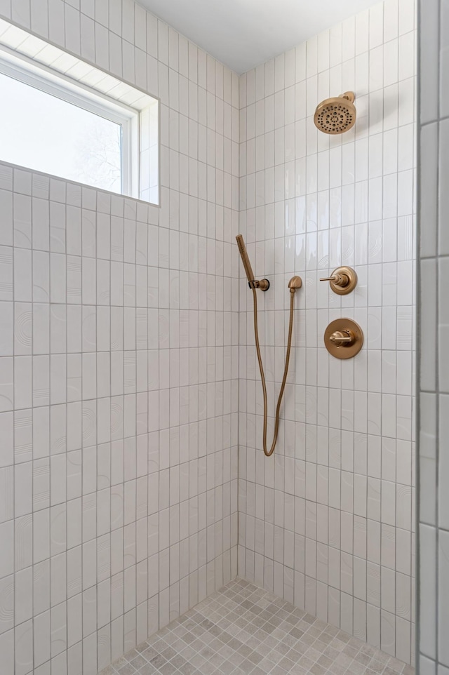 bathroom with tiled shower