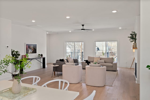 dining space with baseboards, a ceiling fan, recessed lighting, and light wood-style flooring