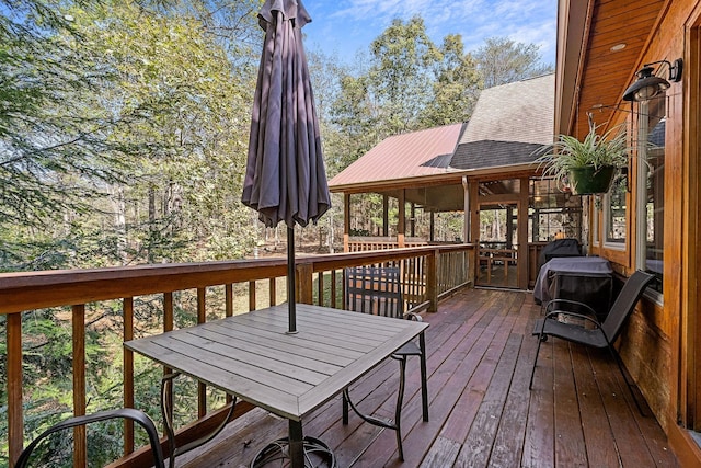 wooden deck featuring outdoor dining area