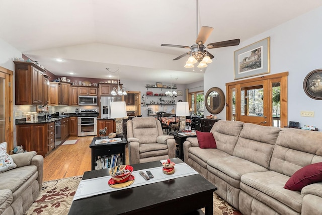 living room with recessed lighting, lofted ceiling, light wood finished floors, and ceiling fan with notable chandelier
