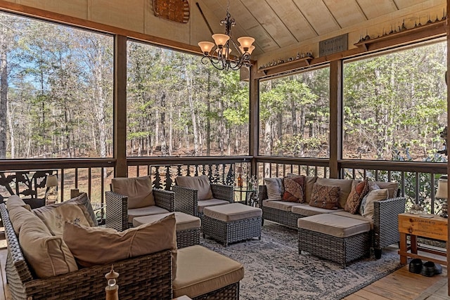 sunroom / solarium with a healthy amount of sunlight, an outdoor hangout area, and a chandelier