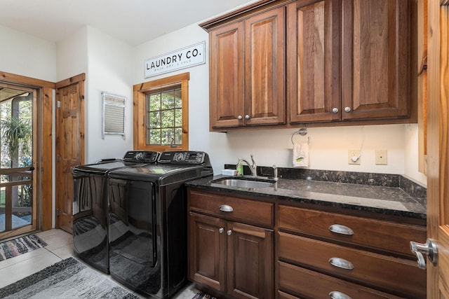 laundry area with a sink, cabinet space, light tile patterned floors, and washer and dryer