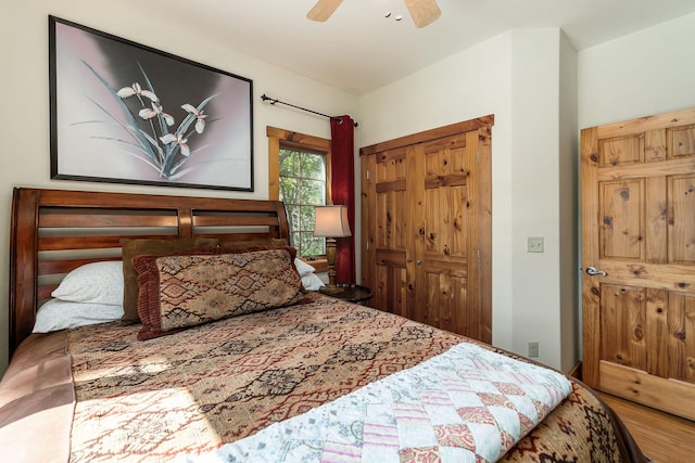 bedroom featuring a closet, a ceiling fan, and wood finished floors