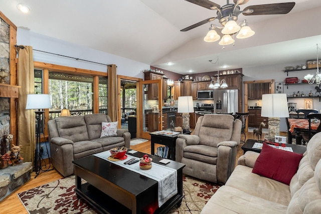 living room with recessed lighting, ceiling fan with notable chandelier, light wood finished floors, and lofted ceiling
