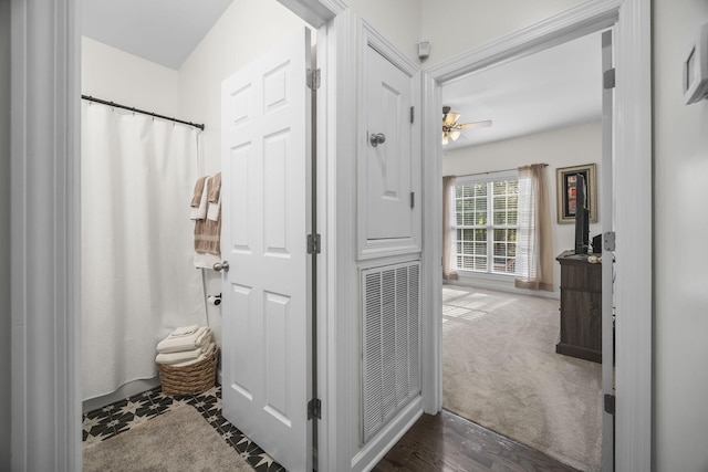 bathroom with ceiling fan, visible vents, and a shower with shower curtain