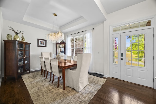 dining area featuring baseboards, an inviting chandelier, and wood finished floors
