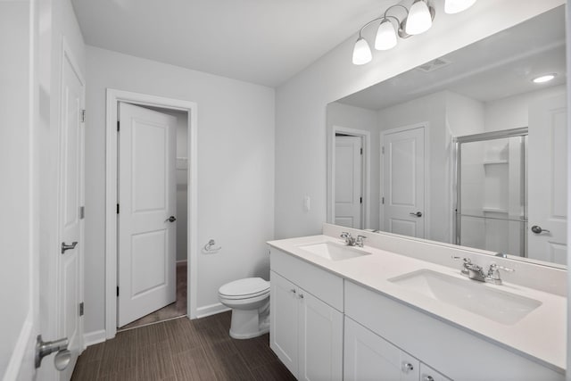 3021 Posada Ct, Spring Hill, TN 37174 - bathroom featuring toilet, visible vents, a sink, and a stall shower