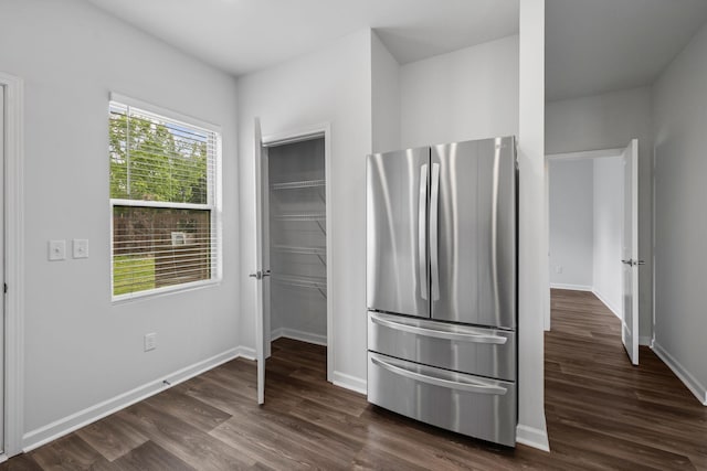 3021 Posada Ct, Spring Hill, TN 37174 - unfurnished bedroom featuring freestanding refrigerator, baseboards, dark wood-style floors, and a walk in closet